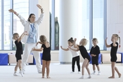 Academy coach Olesya Kovaleva with young gymnasts during training