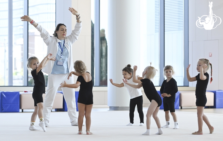 Academy coach Olesya Kovaleva with young gymnasts during training