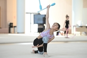 A gymnast from China during the exercise with clubs when training