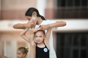 Coach Elizaveta Chernova and a young gymnast during a training