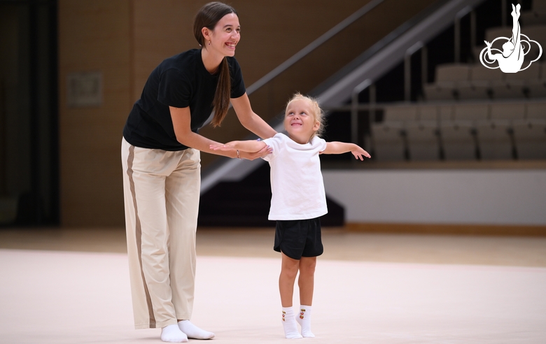 Academy coach Elizaveta Chernova with a young gymnast during the selection