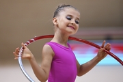 Young gymnast during an exercise with a hoop at the mAlinka tournament