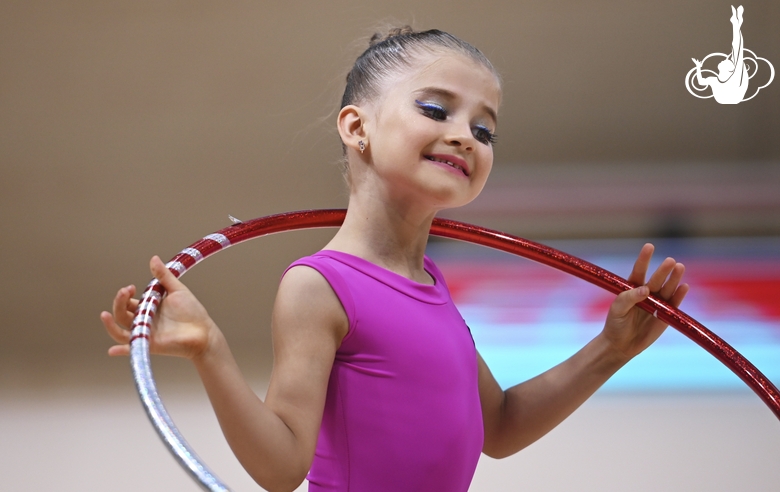 Young gymnast during an exercise with a hoop at the mAlinka tournament