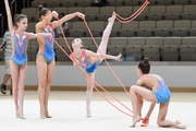 A team of gymnasts in an exercise with a rope during a performance at the Formula of Victory competition