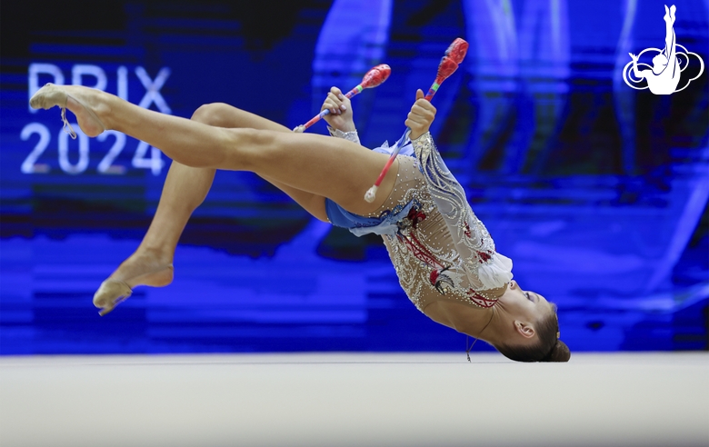 Gymnast during an exercise with clubs