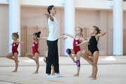 Coach Elizaveta Chernova and young gymnasts during a training