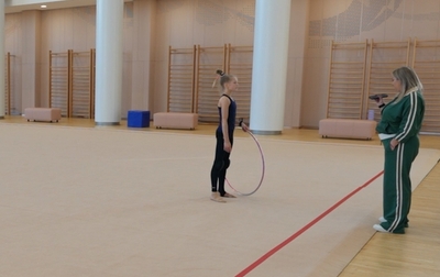 Olympic champion Alina Kabaeva helps Eva Kononova practice fouetté