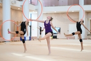 Gymnasts performing an exercise with hoops