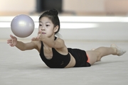 Chinese gymnast performs an exercise with a ball