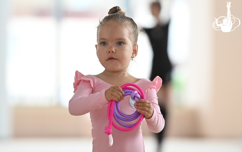 Young gymnast during an exercise with a jump rope