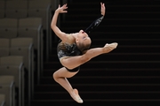 Gymnast performs a jump during the Formula of Victory competition