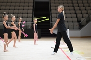 Coach Elizaveta Zorkina with gymnasts during practice at the training camp in the Academy