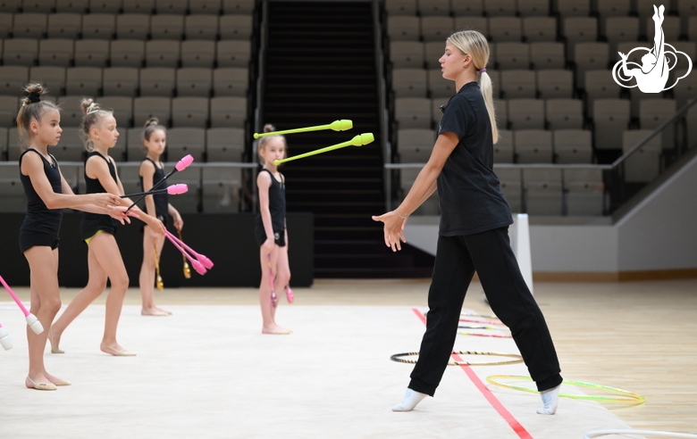 Coach Elizaveta Zorkina with gymnasts during practice at the training camp in the Academy