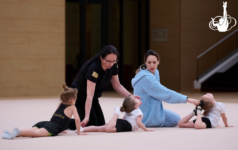 Academy coaches with young gymnasts during the selection process