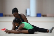 Coach Dominique Adama and gymnast Nkenko Sita Davina Chanselvi from the Republic of Congo when stretching