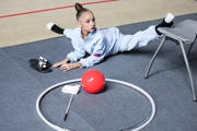 Ksenia Savinova stretches during the warm-up ahead of the start of the tournament