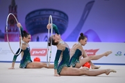 Group team gymnasts from Belarus during an exercise with balls and hoops