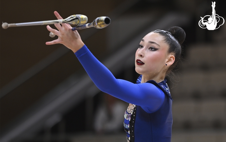 Gymnast during an exercise with clubs