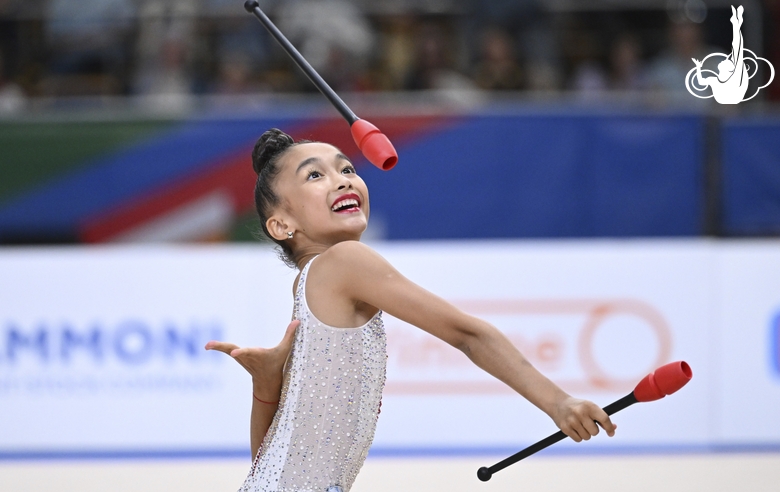 Asel Arapova  during an exercise with clubs