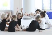 Academy coach Olesya Kovaleva with young gymnasts during training