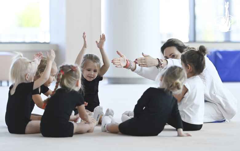 Academy coach Olesya Kovaleva with young gymnasts during training