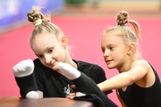 Lada Yakovleva and Darina Budnikova during stretching at floor testing