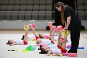 Young gymnasts with the coach during the training session