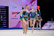 Group team gymnasts from Belarus during an exercise with balls and hoops