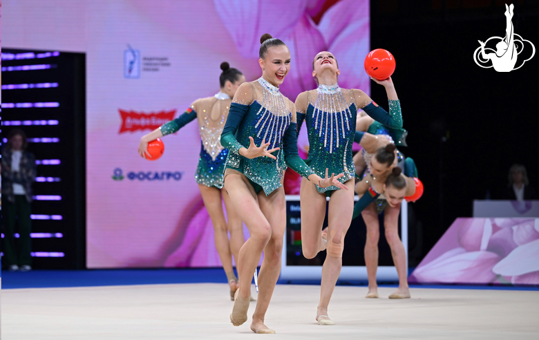 Group team gymnasts from Belarus during an exercise with balls and hoops