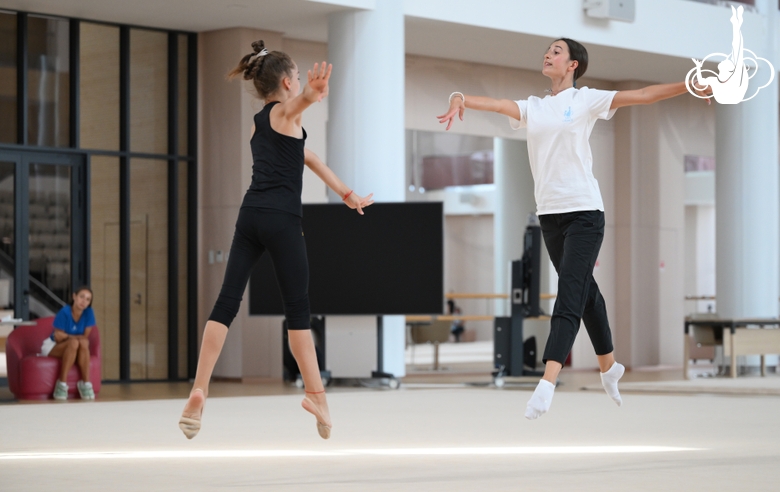 Coach Elizaveta Chernova with gymnasts during practice at the training camp in the Academy
