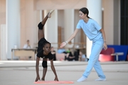 Academy coach Elizaveta Chernova with gymnast Nkenko Sita Davina Chanselvi during the hoop exercise