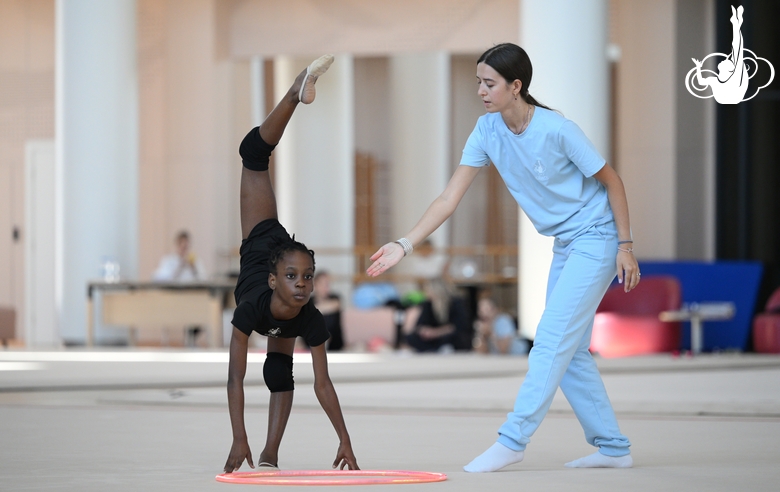 Academy coach Elizaveta Chernova with gymnast Nkenko Sita Davina Chanselvi during the hoop exercise