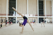 Gymnast practicing an element on the mat