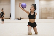 A young gymnast from China during the ball exercise