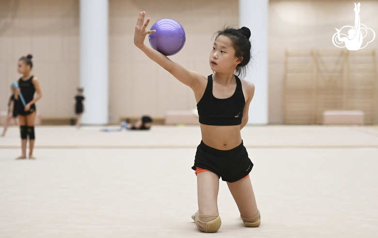 A young gymnast from China during the ball exercise