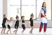 Academy coach Olesya Kovaleva with young gymnasts during training