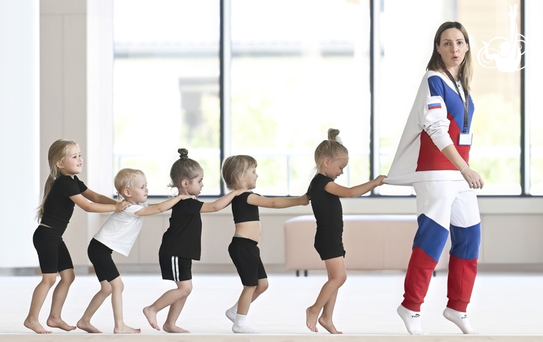 Academy coach Olesya Kovaleva with young gymnasts during training