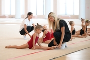 Coaches Elizaveta Chernova, Elizaveta Zorkina and young gymnasts during training