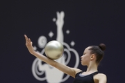 Gymnast during an exercise with a ball at floor testing