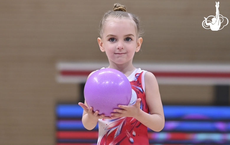 Young gymnast during an exercise with a ball at the mAlinka tournament