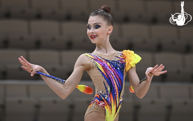 Gymnast during an exercise with clubs