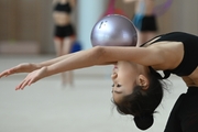 Chinese gymnast performs an exercise with a ball