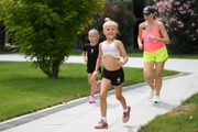 Academy coach Olesya Kovaleva and young gymnasts during a run