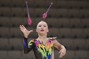 Gymnast during an exercise with clubs