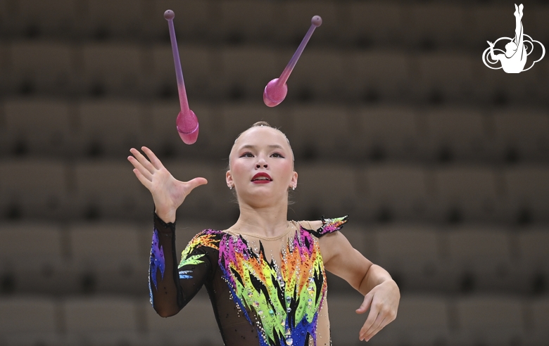 Gymnast during an exercise with clubs