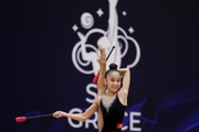 Gymnast during an exercise with clubs