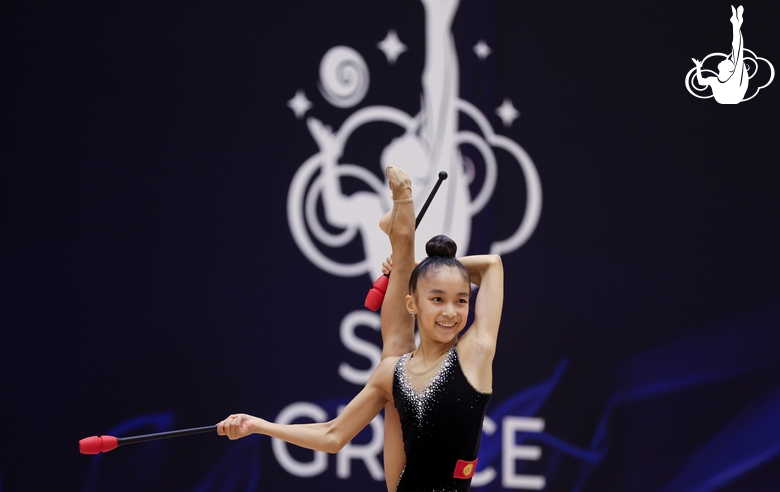 Gymnast during an exercise with clubs