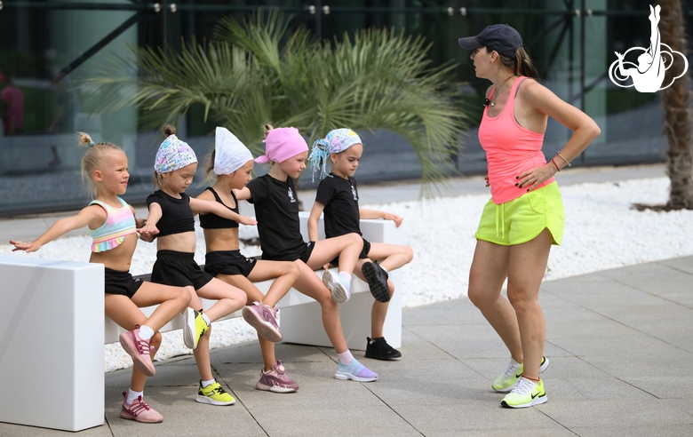 Academy coach Olesya Kovaleva and young gymnasts during training