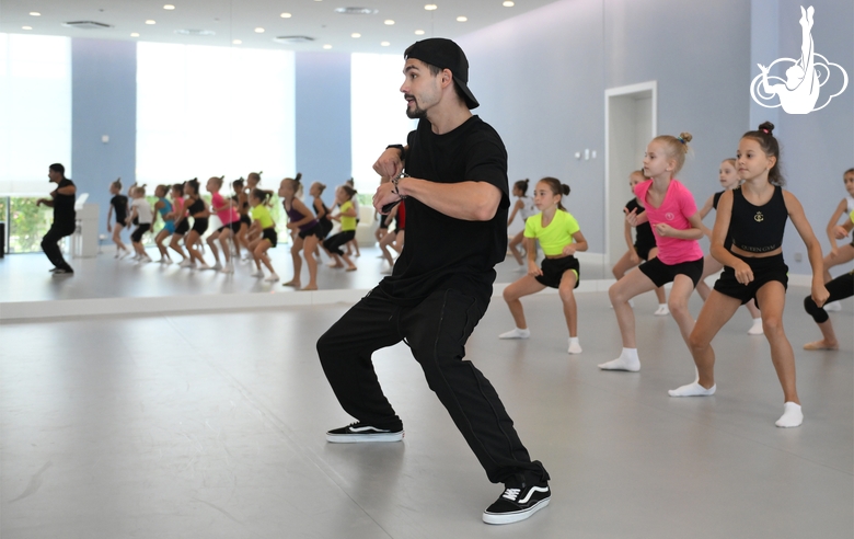 Choreographer Artur Nureev with gymnasts during practice at the training camp in the Academy