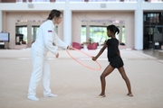 Academy coach Olesya Kovaleva with gymnast Nkenko Sita Davina Chanselvi during the hoop exercise